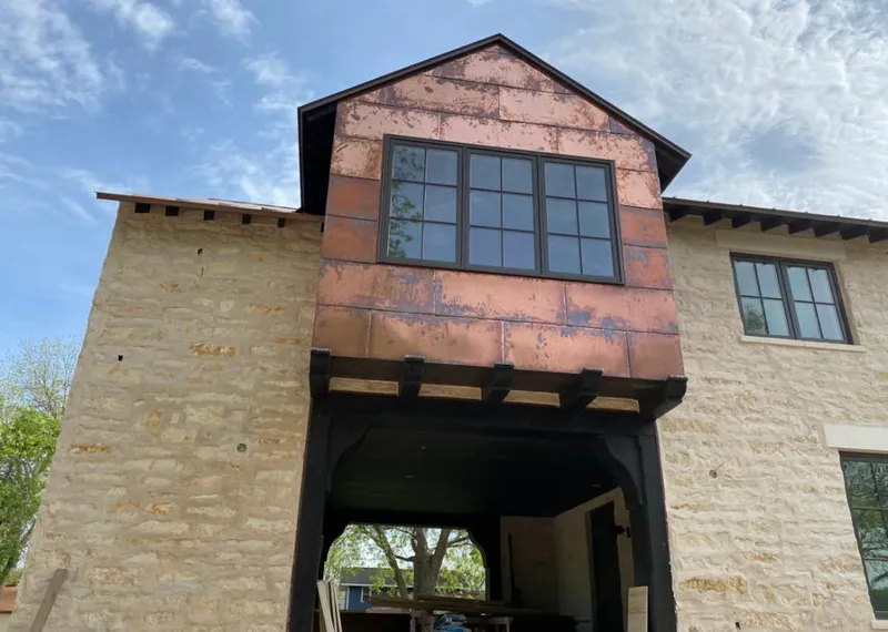 Copper metal panel facade on a stone building for Skylight Installation in Harborcreek