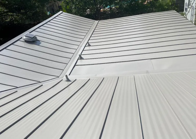 Solar attic fan installed on a metal roof for Roof Ventilation in Harborcreek