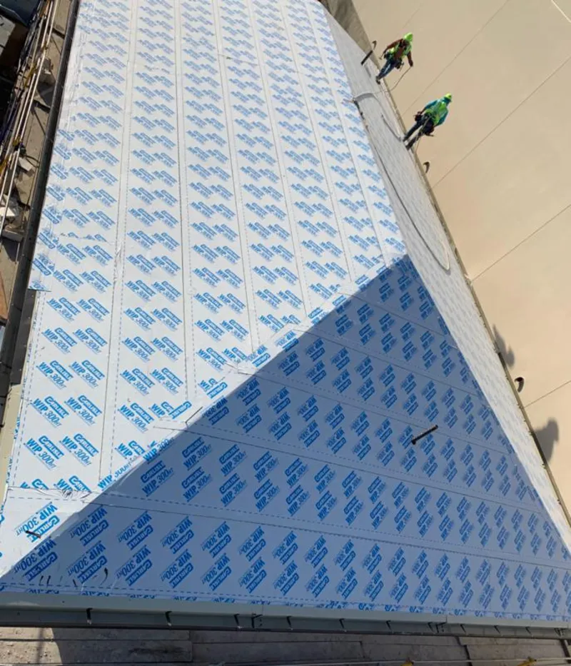 Professional roofers installing underlayment on a metal roof in Harborcreek